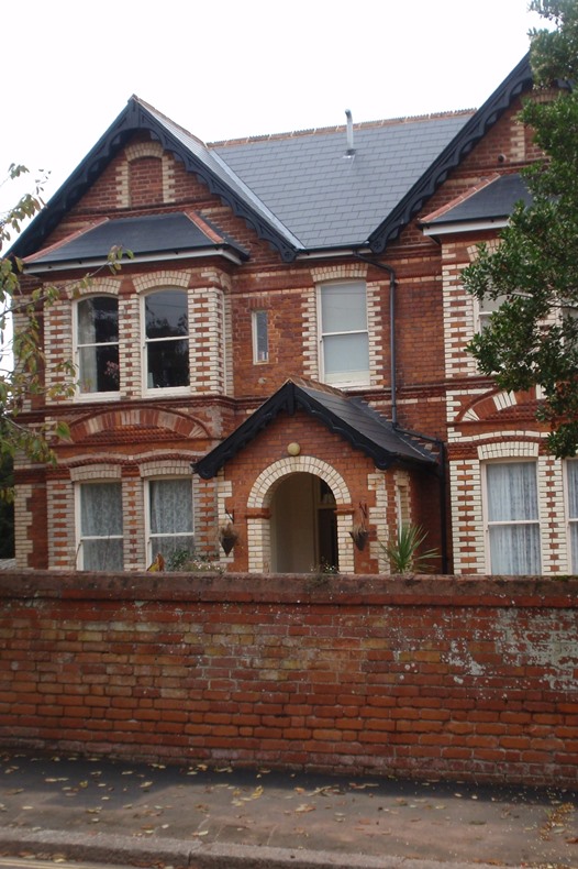 Large house with brick wall